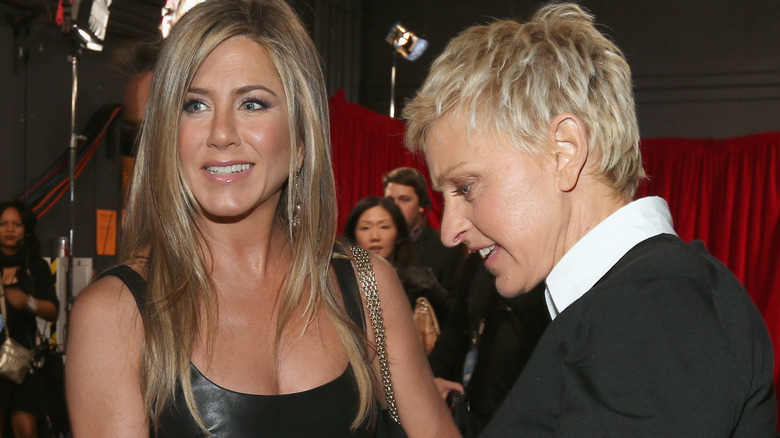 Jennifer Aniston smiling and Ellen DeGeneres talking