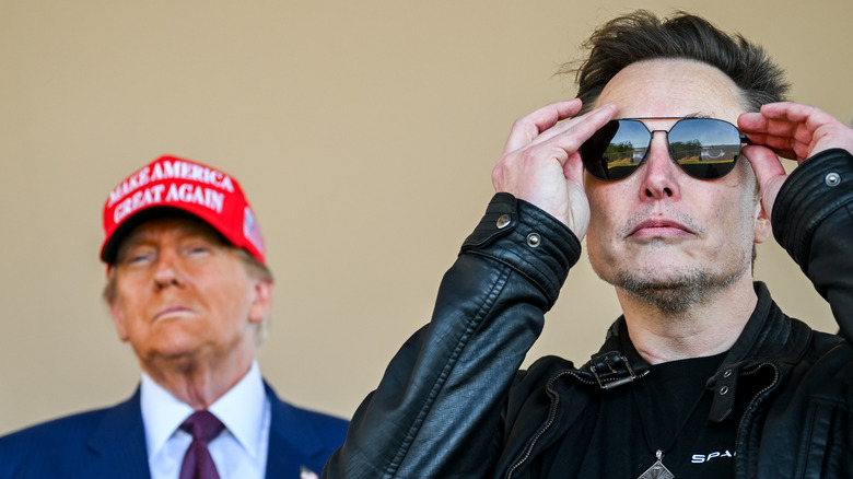 Donald Trump wearing MAGA hat and Elon Musk with sunglasses on