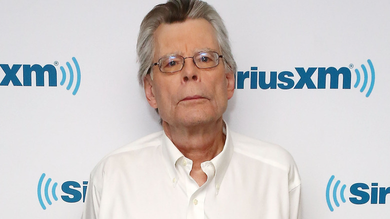 Stephen King wearing a white shirt at a red carpet