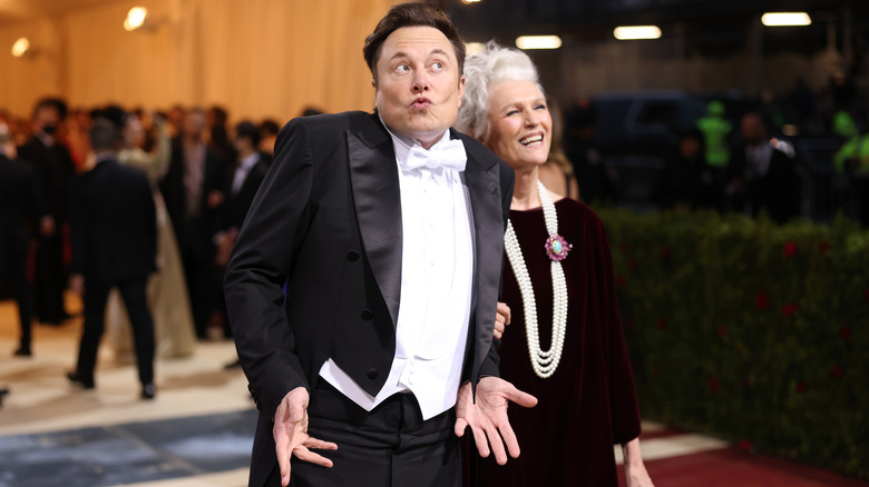 Elon Musk acting goofy in a tux