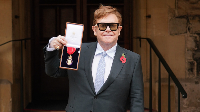 Elton John receiving the the Order of the Companions of Honour