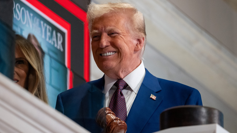 Donald Trump smiling while at the stock market.