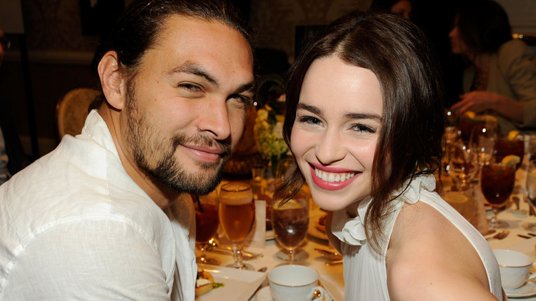 Jason Momoa and Emilia Clarke smiling