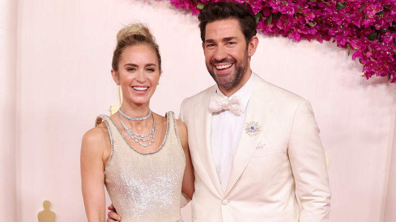 Emily Blunt and John Krasinski smiling together at red carpet event