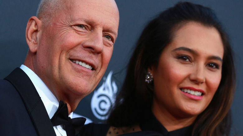 Bruce Willis and Emma Heming posing