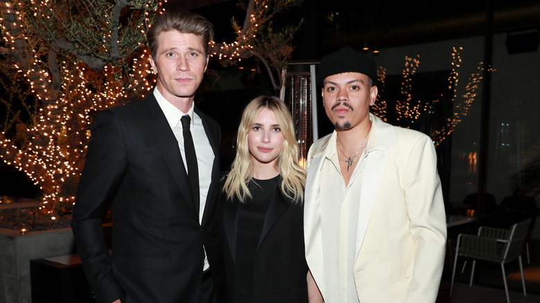 Garrett Hedlund, Emma Roberts, and Evan Ross pose side-by-side