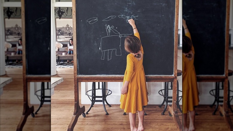 Emmie Gaines writing on a chalkboard