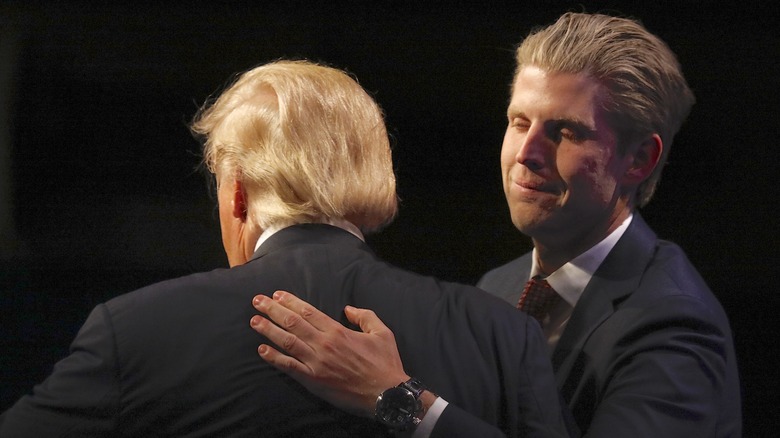 Eric Trump patting Donald Trump on the back