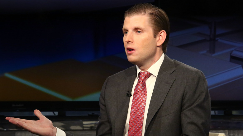 Eric Trump holding hand up