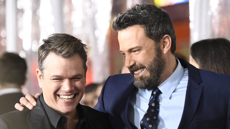 Ben Affleck with his arm around Matt Damon