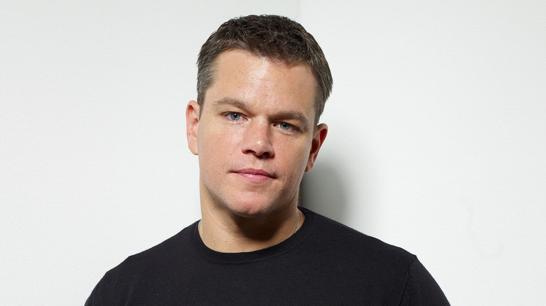 Matt Damon standing against a wall