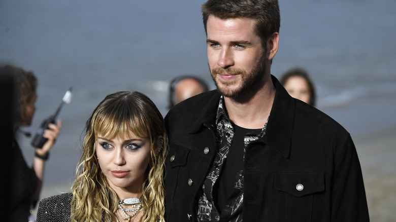 Miley Cyrus and Liam Hemsworth smiling