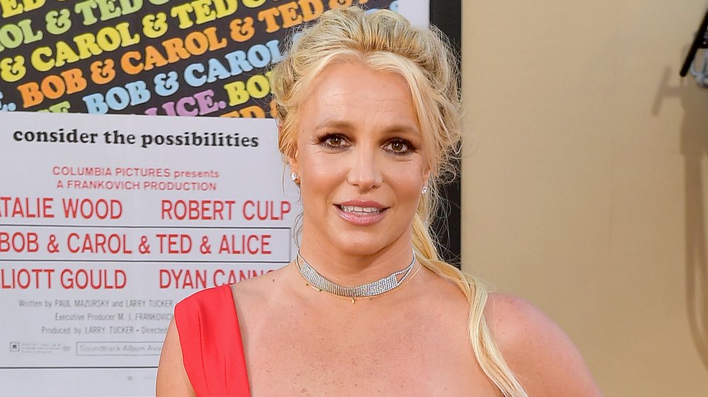 Britney Spears with hair pulled back in red dress