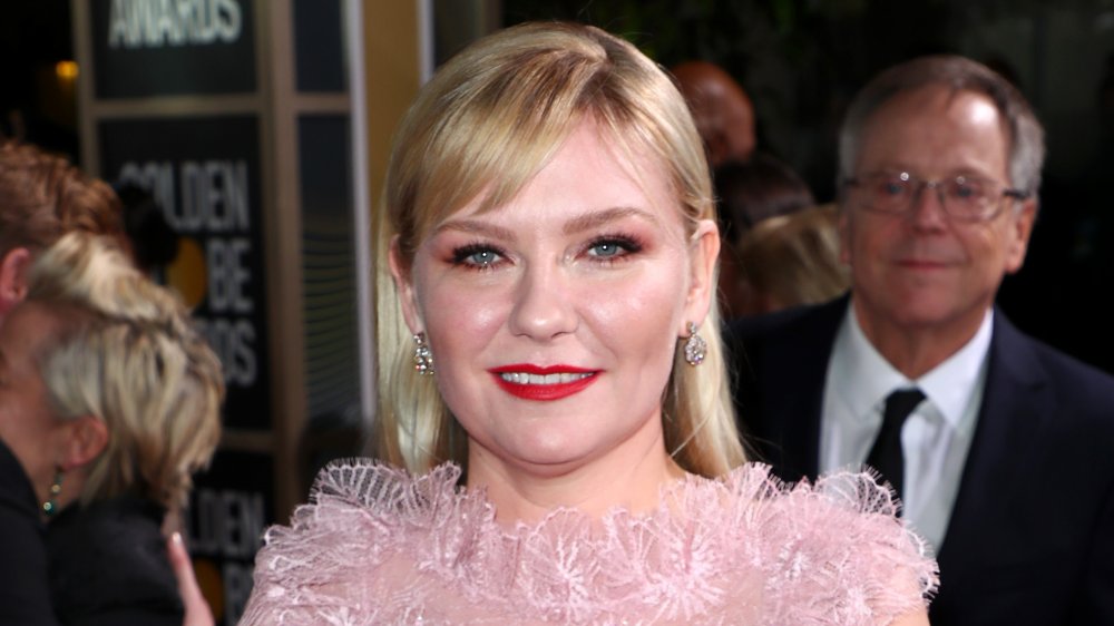 Kirsten Dunst with red lipstick and pink dress