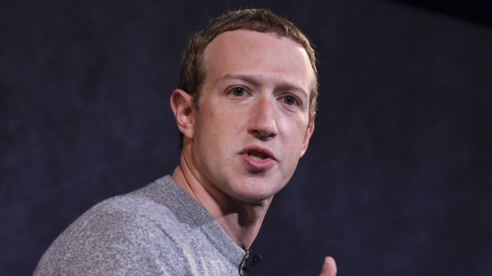 Mark Zuckerberg giving speech, hands up in air