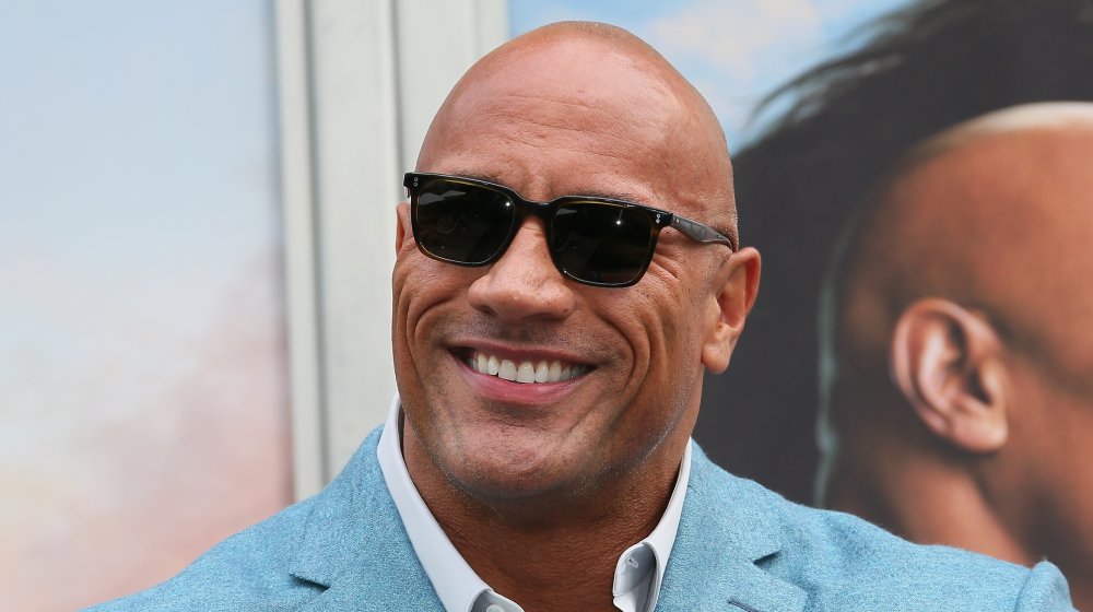The Rock, grinning with sunglasses on