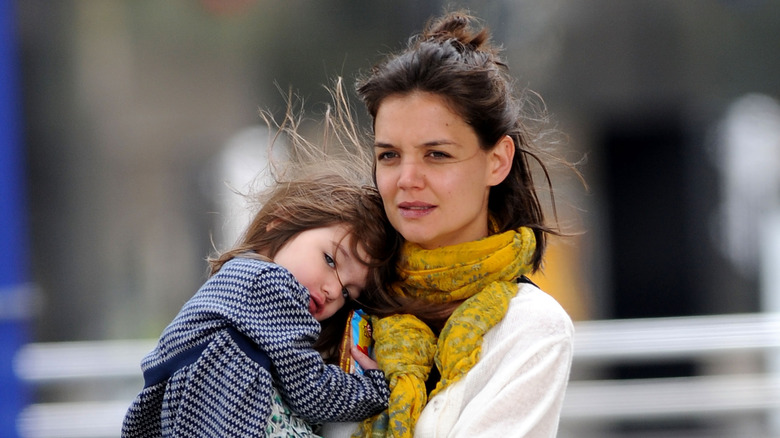 Katie Holmes carrying daughter Suri Cruise