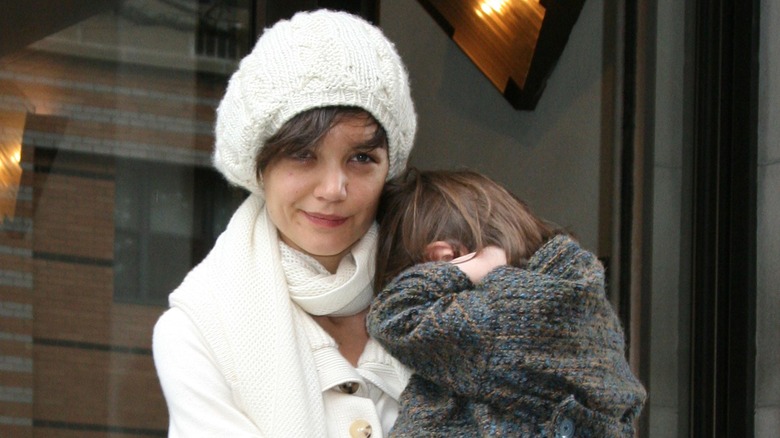 Katie Holmes beret, carrying Suri Cruise