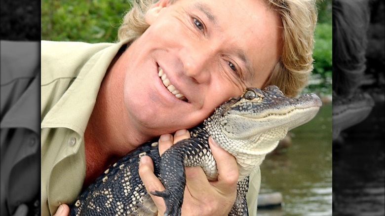 Steve Irwin holding baby crocodile to his face