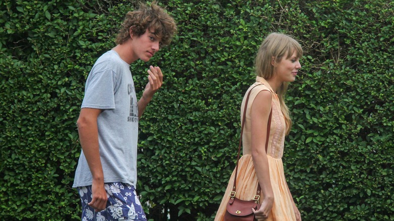 Conor Kennedy walking behind Taylor Swift