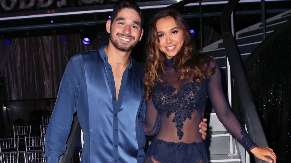 Alan Bersten and Alexis Ren smiling