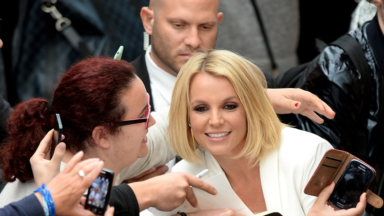 Britney Spears posing with supporters