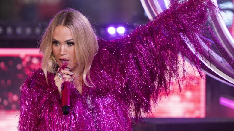 Carrie Underwood performs in pink during Dick Clark's New Year's Rockin' Eve in New York City (2024)