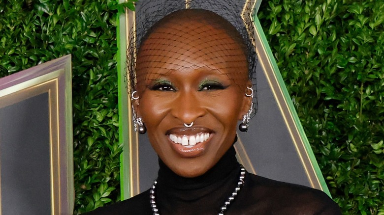 Cynthia Erivo smiles in a black turtleneck and silver jewelry