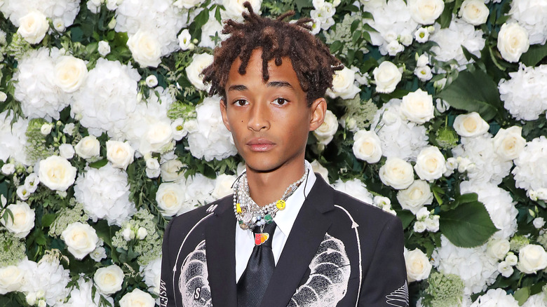 Jaden Smith in front of flower wall