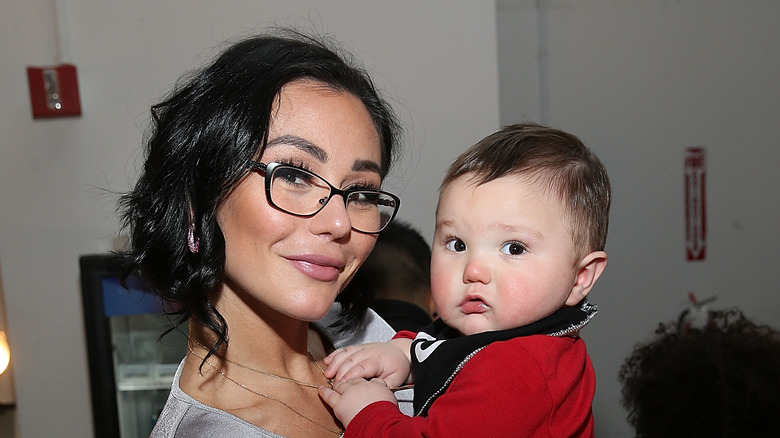 Jenni 'JWoww' Farley holding son Greyson and smiling