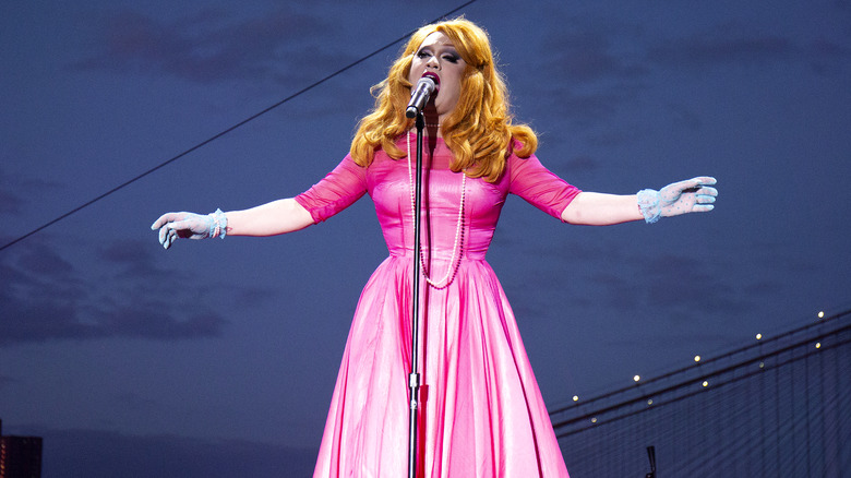 Jinkx Monsoon singing into a microphone onstage