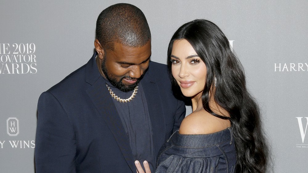 Kanye West looking down at Kim Kardashian West, both smiling at the WSJ. Magazine 2019 Innovator Awards