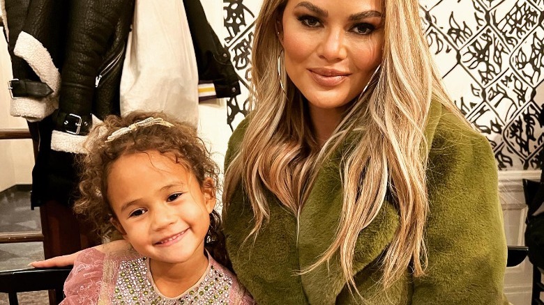 Chrissy Teigen and her daughter Luna at dinner, smiling