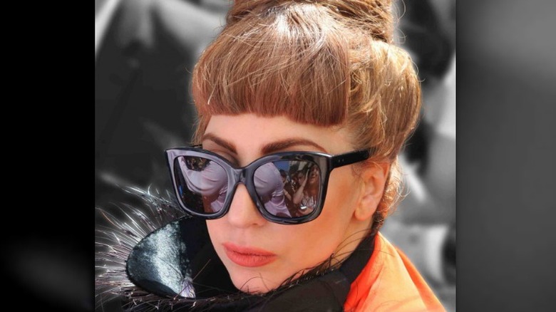Lady Gaga wearing sunglasses with brown hair