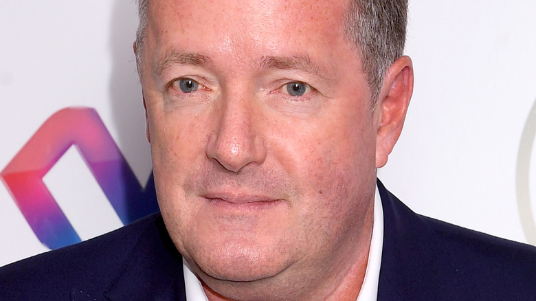 Piers Morgan staring sadly black jacket