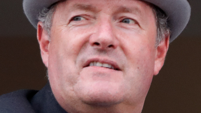 Piers Morgan sneering gray hat