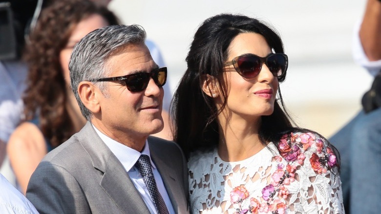 George Clooney and Amal Clooney wearing sunglasses