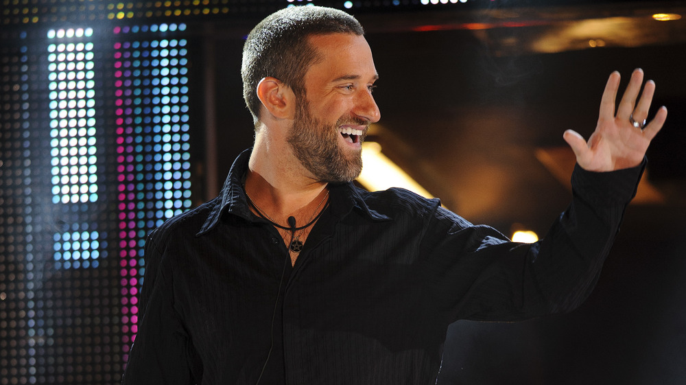 Dustin Diamond smiling and waving