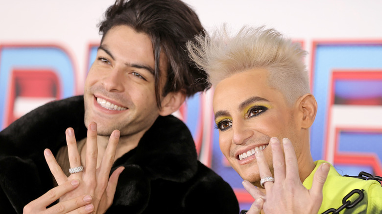 Hale Leon and Frankie Grande posing with rings