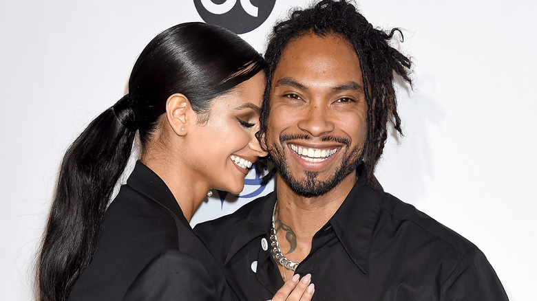 Miguel and Nazanin Mandi smiling on the red carpet