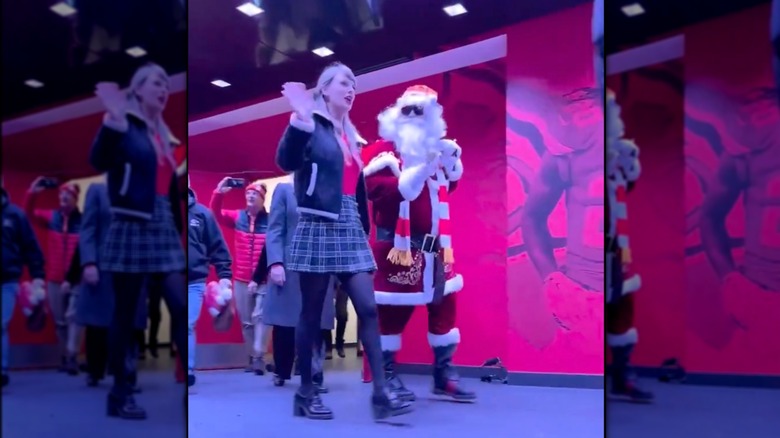 Austin Swift dressed as Santa and walking with Taylor Swift