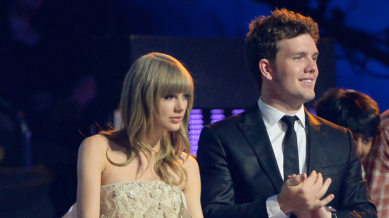 Austin and Taylor Swift standing in the audience at an awards show