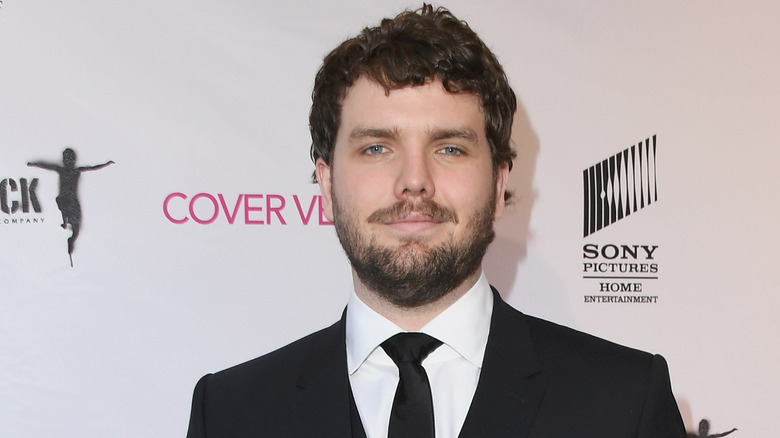 Austin Swift posing at an event