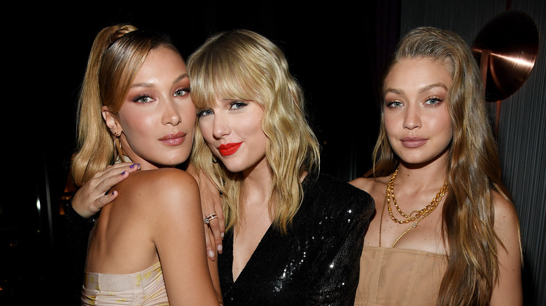 Taylor Swift poses with Bella Hadid, left, and Gigi Hadid, right