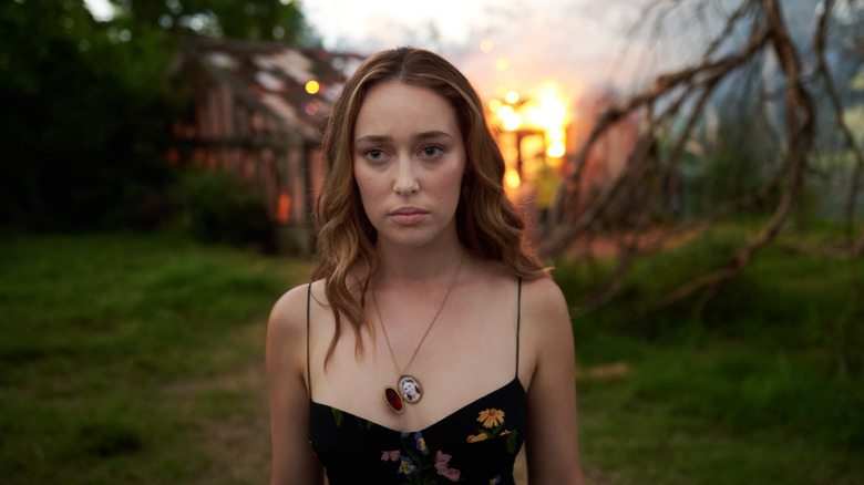 Alycia Debnam-Carey with fire in background