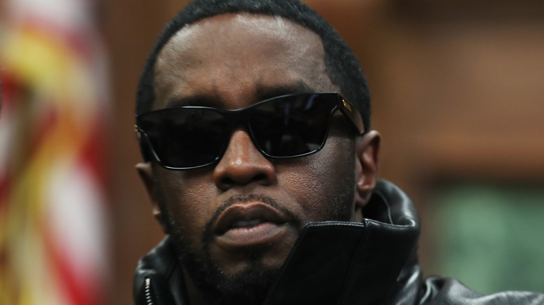 Sean Combs posing behind sunglasses