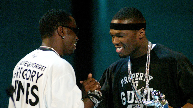 Diddy and 50 Cent clasping hands