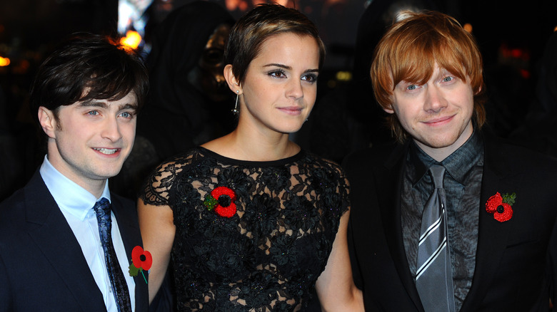 Daniel Radcliffe, Emma Watson, and Rupert Grint smiling