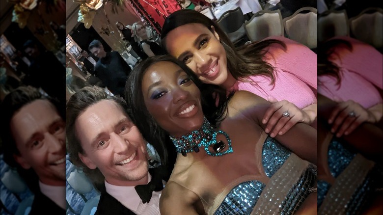 Tom Hiddleston, AJ Odudu, and Zawe Ashton smiling