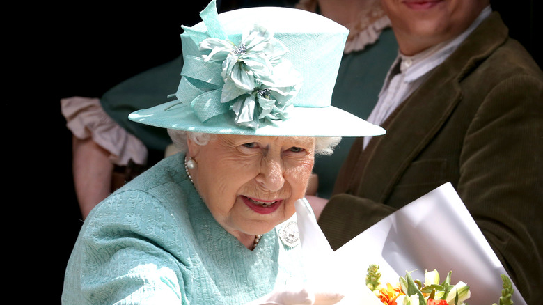 Queen Elizabeth II in blue hat